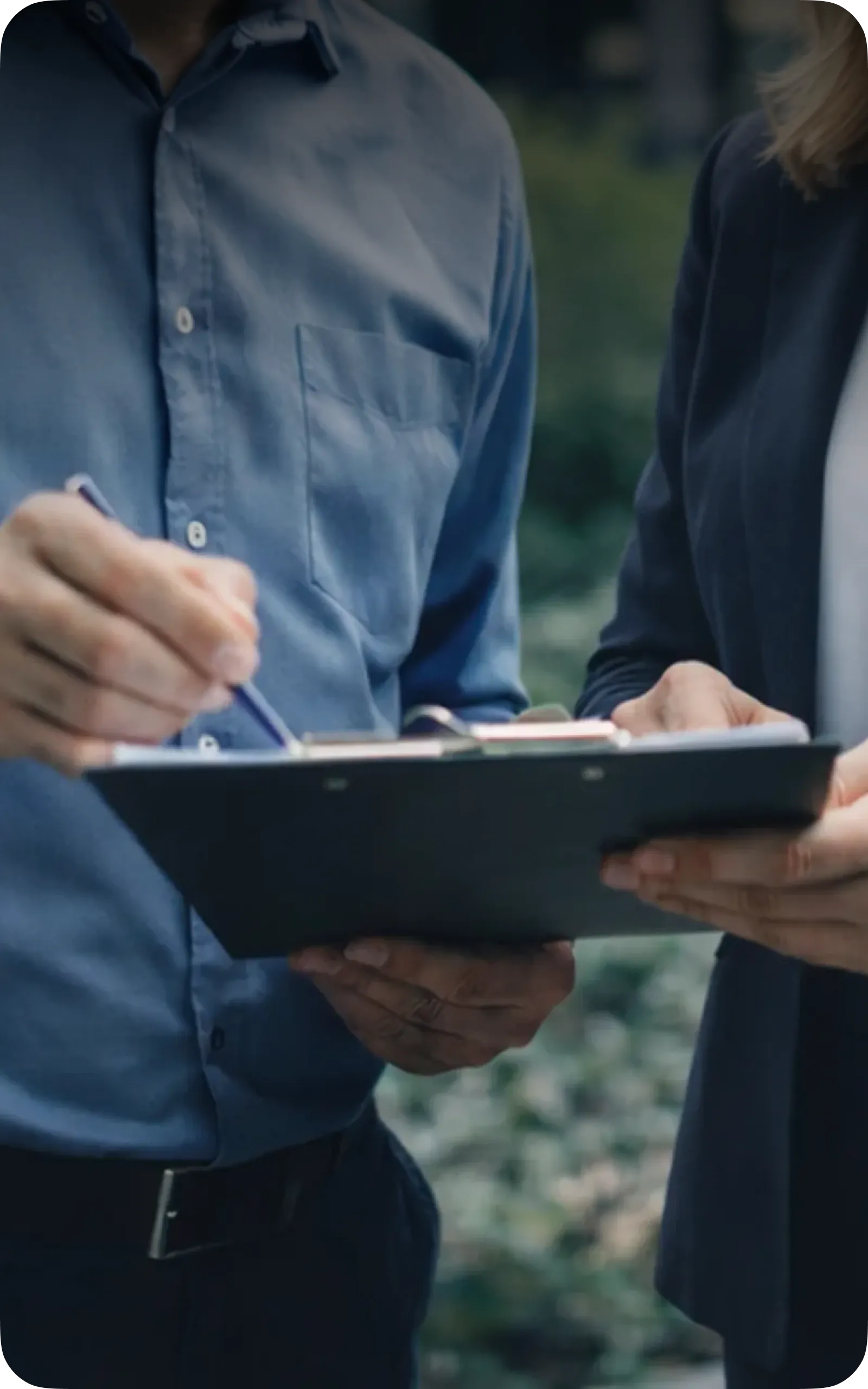 Two people reviewing a site plan